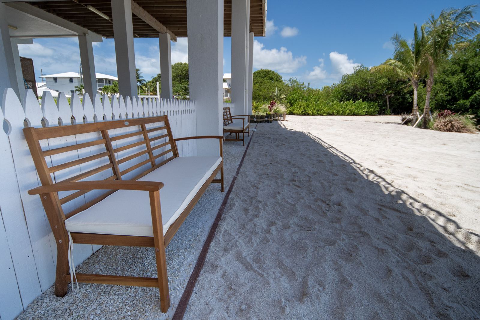 Bench on the private sandy beach beneath the house