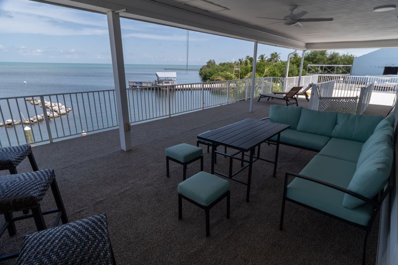The covered balcony with lounge seating overlooking the Gulf