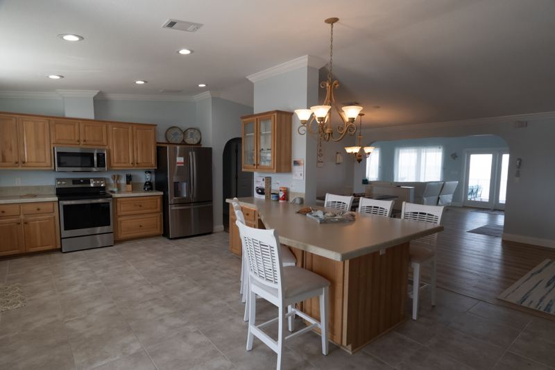 Open kitchen with stainless steel appliances and a breakfast bar