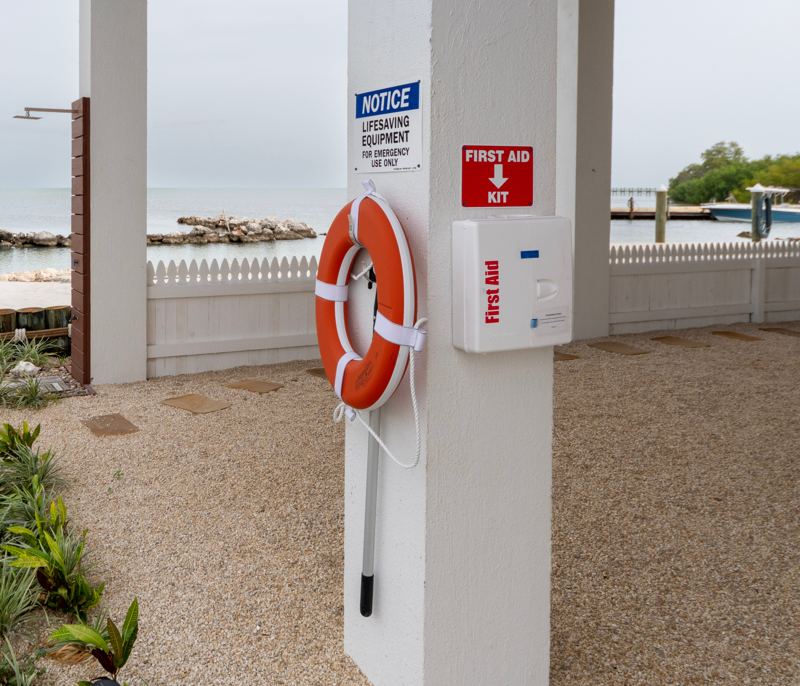 Life ring, rescue hook and first aid kit posted near the pool